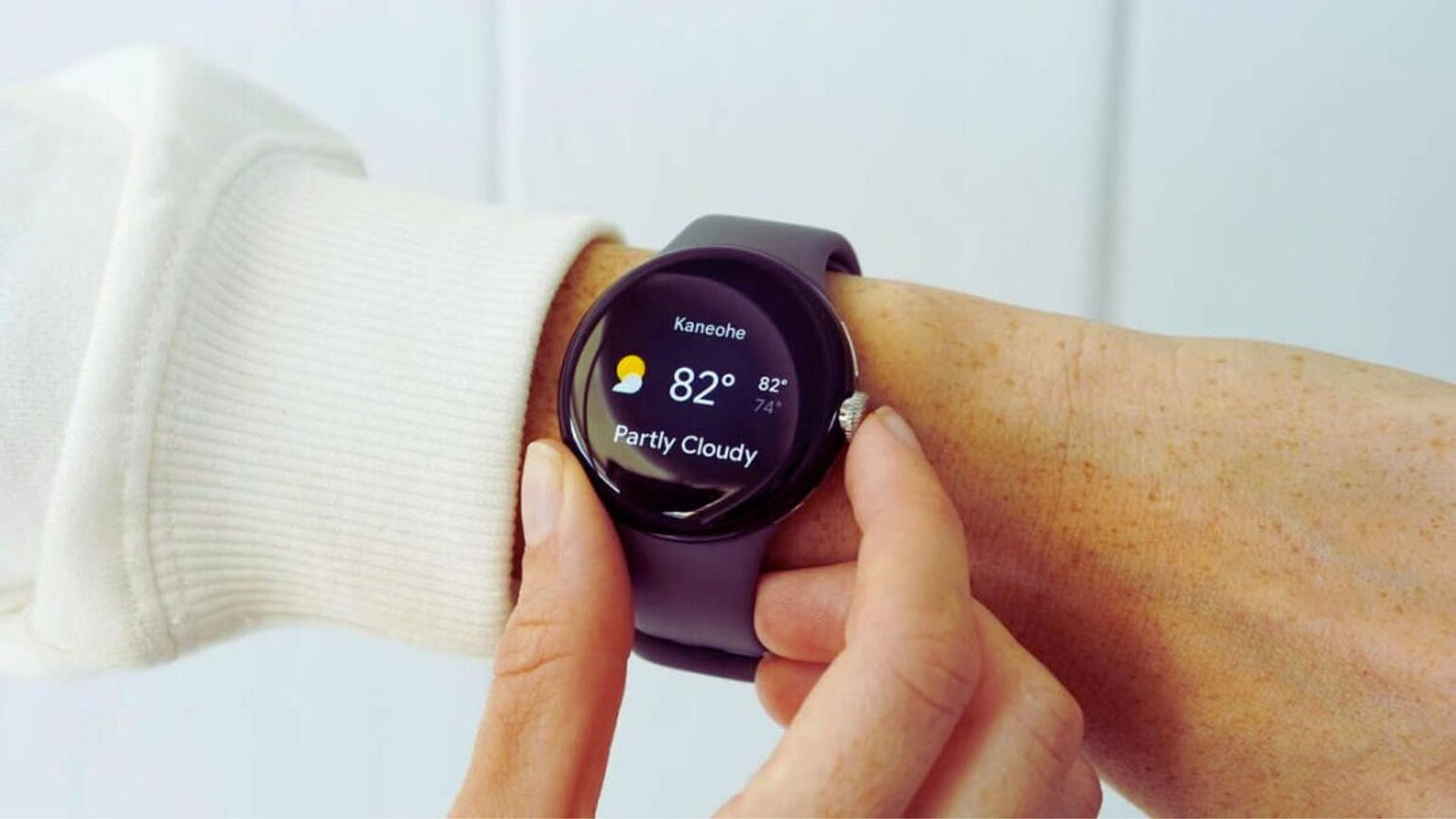 Alt text: Personale che guarda l'orologio smart sulla mano, con display che mostra il tempo e il meteo, ideale per tecnologia wearable e fitness.